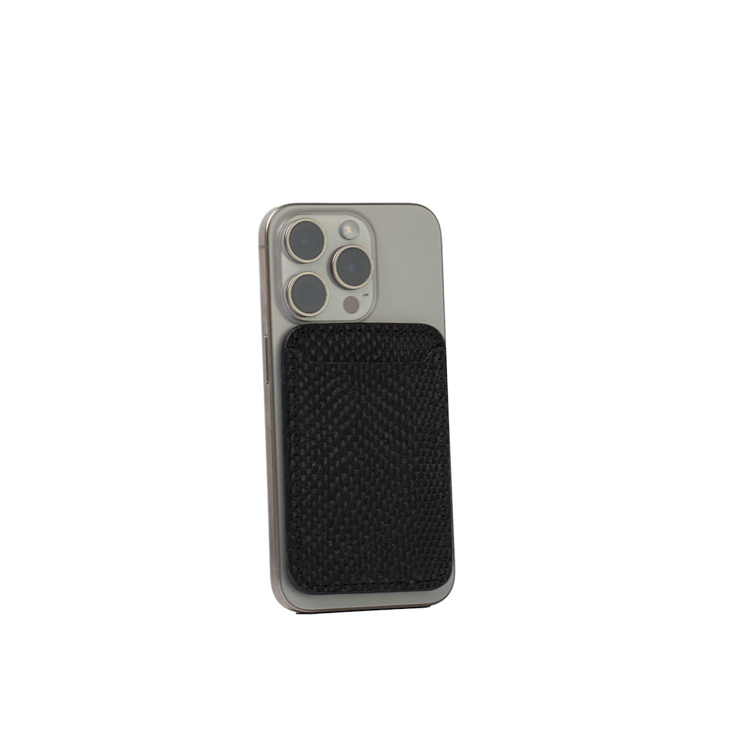 Black embossed snake print leather wallet with MagSafe attached to silver iPhone.