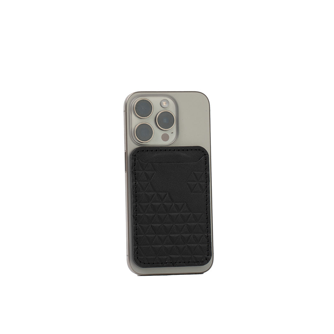 Black leather wallet with geometric diamond pattern attached to iPhone using MagSafe magnet