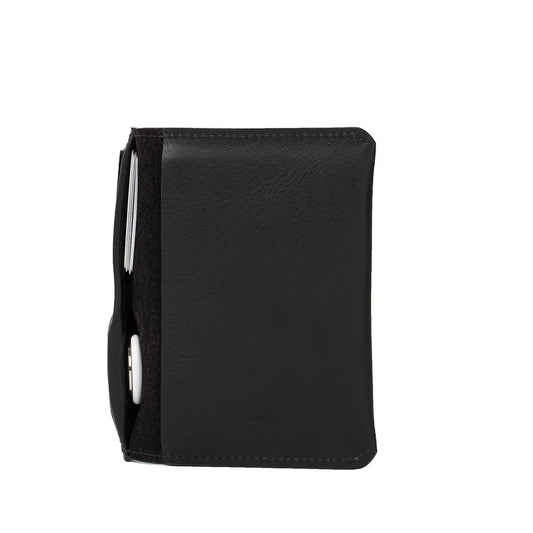 Black full-grain Italian leather passport holder with RFID-blocking pocket and hidden AirTag slot