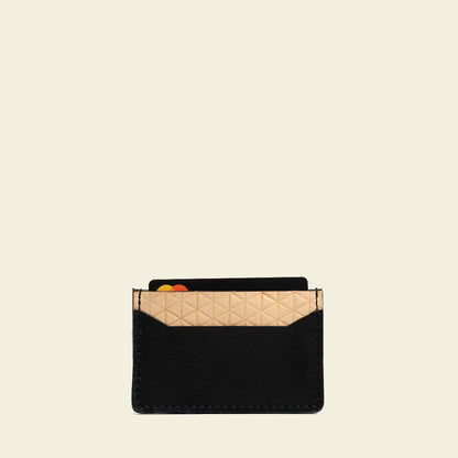 Minimalist leather card holder with geometric net design, handcrafted in Europe, holds two cards.