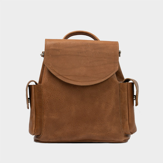 Brown leather backpack Chatelet with two exterior pockets and top handle, compact designer mini rucksack.