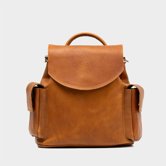 Tan small leather backpack with two side pockets and top handle, made from Italian vegetable-tanned leather