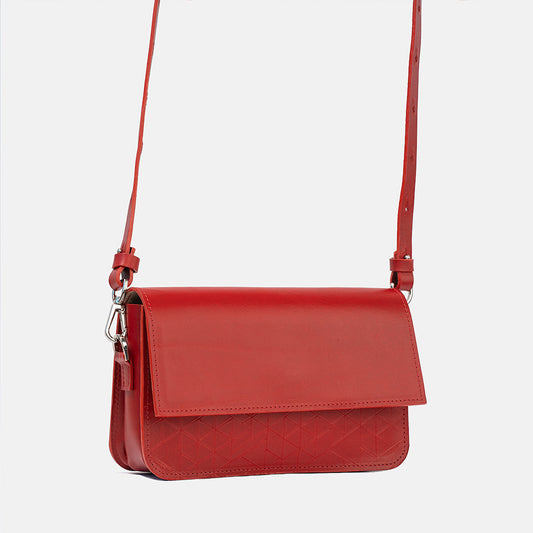 Red leather shoulder bag with geometric vector pattern and adjustable strap