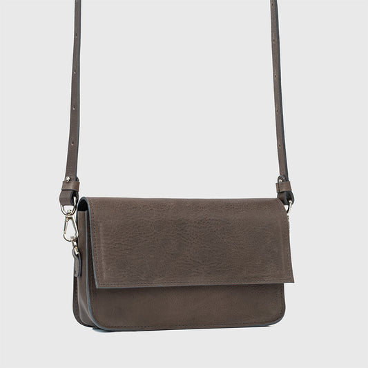 Gray leather shoulder bag with adjustable strap and flap closure, stylish and functional design