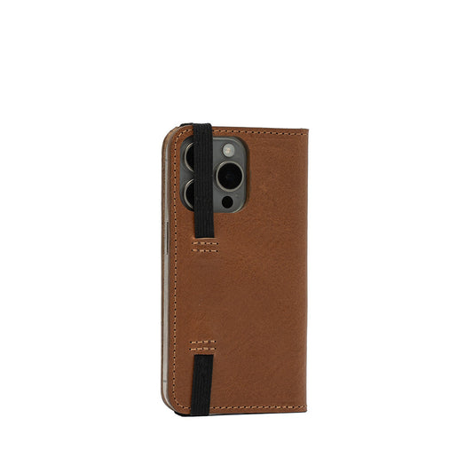 Brown full-grain leather folio case with MagSafe for iPhone 15 Pro featuring elastic straps and hand-stitched detailing.