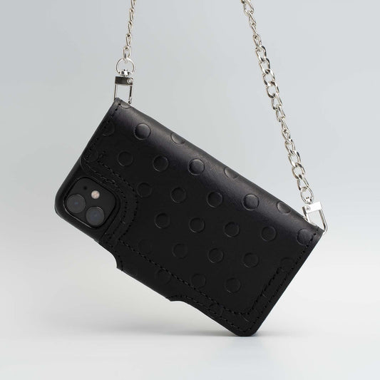 Black leather crossbody case with polka dot design and silver chain for iPhone 11.