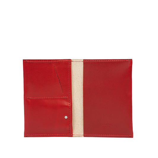 Red leather AirTag passport holder with multiple card slots and a hidden AirTag pocket.