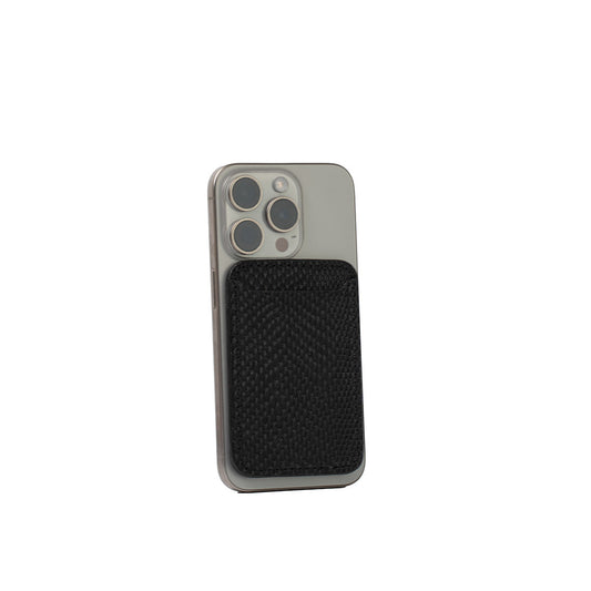 Black embossed snake print leather wallet with MagSafe attached to silver iPhone.