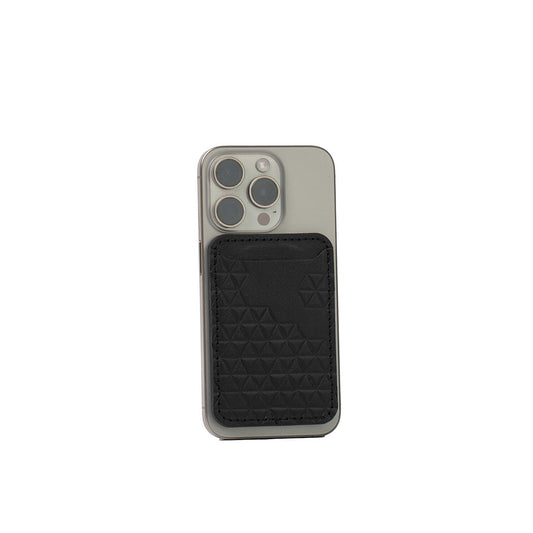 Black leather wallet with geometric diamond pattern attached to iPhone using MagSafe magnet